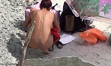 Smal nudistbrud gör saker på en strand (voyeur XXX-video)