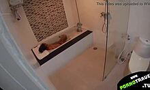 אישה צעירה מתלכלכת בחדר האמבטיה